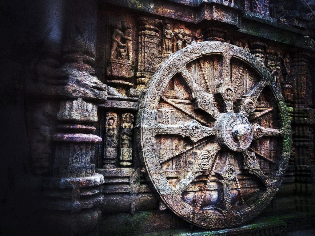 Carriage wheel carved in stone stands at the Konark Sun Temple