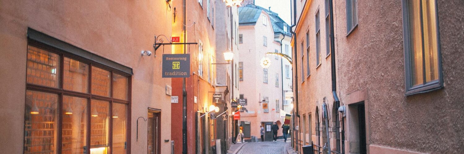 A quiet pedestrian lane in Stockholm as day fades into night.